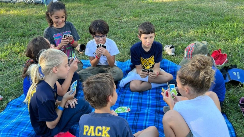 Sitting on blanket playing cards
